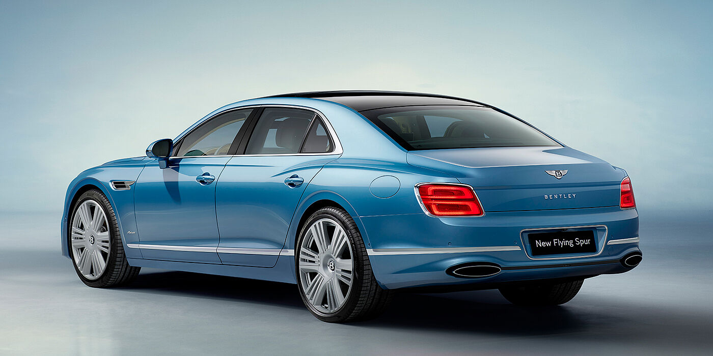 Bentley Lugano New Bentley Flying Spur Azure sedan rear view in Light windsor blue by Mulliner paint with 22 inch Azure wheels and chrome exterior details