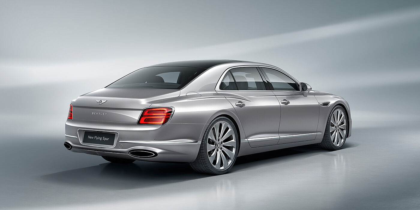 Bentley Lugano New Bentley Flying Spur sedan rear view in Silverlake paint with ten spoke wheels and chrome matrix grille