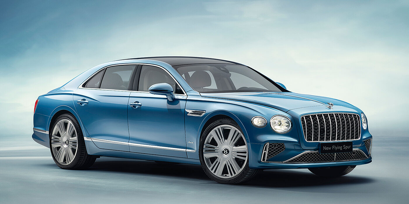 Bentley Lugano New Bentley Flying Spur Azure sedan front view in Light windsor blue by Mulliner paint with 22 inch Azure wheels and chrome exterior details