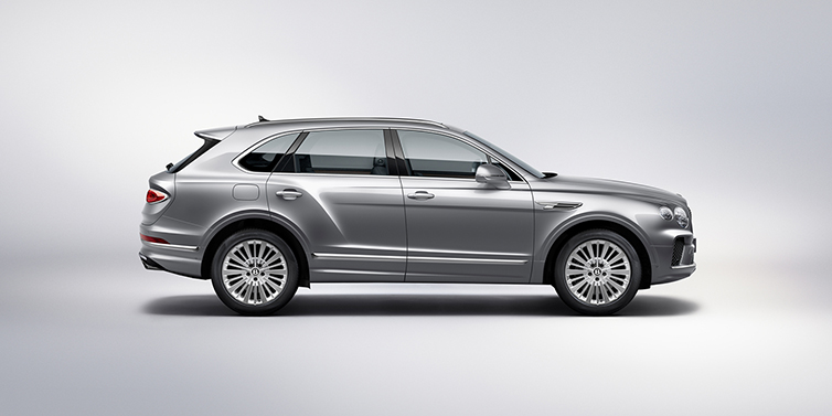 Bentley Lugano Bentley Bentayga SUV side profile in Moonbeam silver paint against white background featuring 21 inch 5 spoke wheels